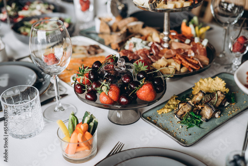 A variety of food on the table  fish  olives  bread  raspberries  meat