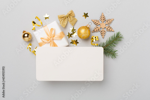Greeting card mockup with christmas decor on color background, top view