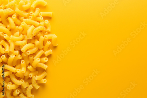 warm macaroni cheese on the table on a yellow background