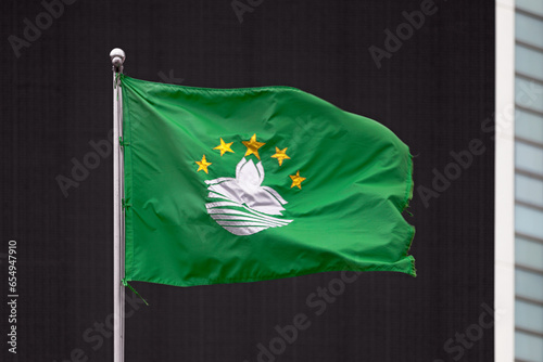 Flag of Macao waving outside a building photo