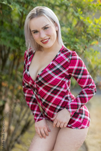 Stunning blonde beauty modeling outdoors in red flannel pajamas