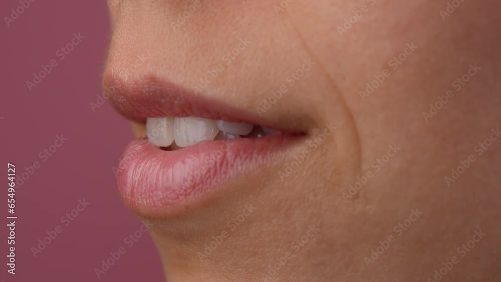 Closeup of female pink lips, open mouth with teeth visible. Macro shot of beautiful caucasian woman part of the face with no makeup. Closeup of female pink lips, open mouth with teeth visible. Macro shot of beautiful caucasian woman part of the face with no makeup.