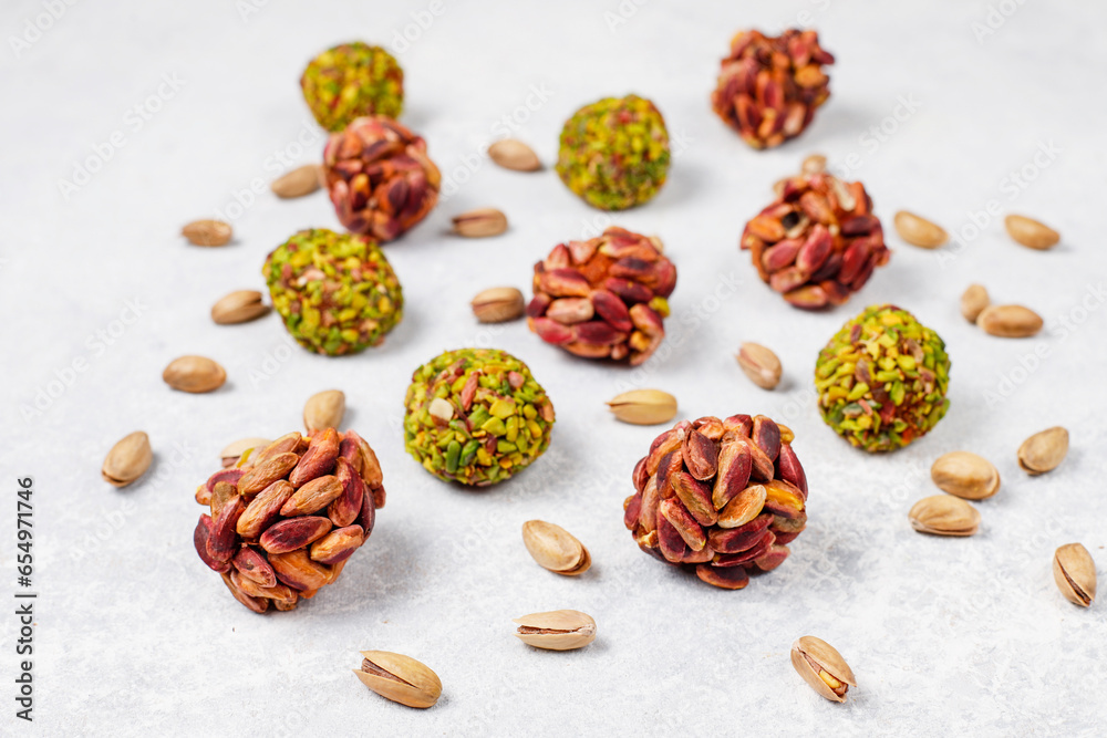 Superfood, raw healthy vegetarian snack, Medjool dates covered by chocolate, and various energy balls with nuts. Superfood, raw healthy vegetarian snack, Medjool dates covered by chocolate, and various energy balls with nuts.