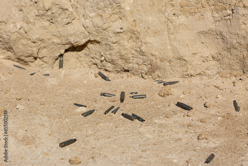 Bullet shells lie on the sand