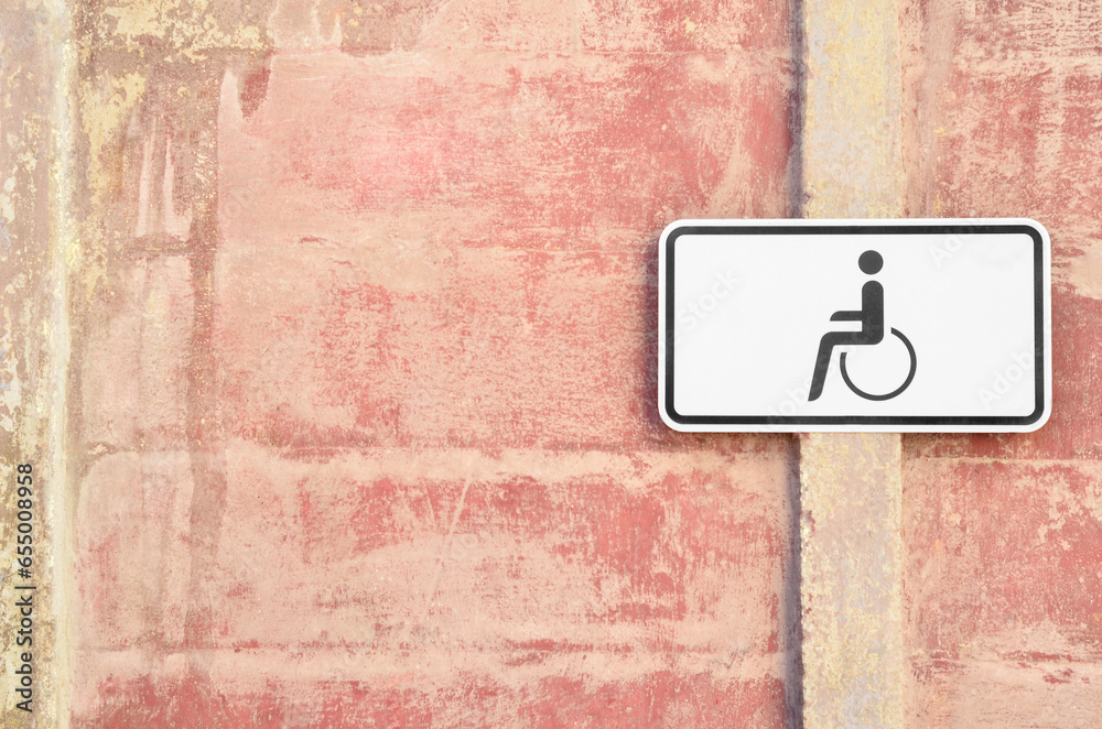 Disabled parking sign on building wall in city Disabled parking sign on building wall in city