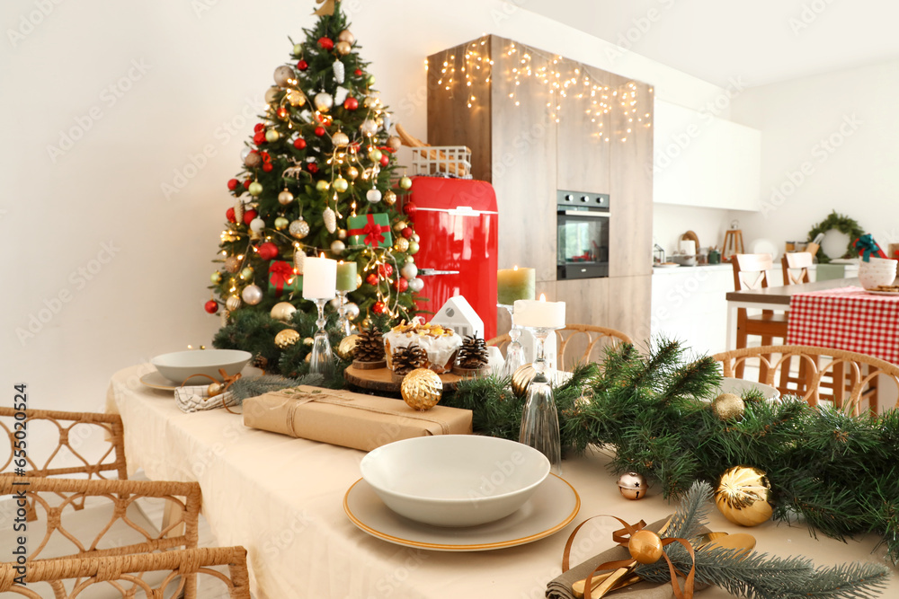 Dining table with Christmas setting and candles in kitchen