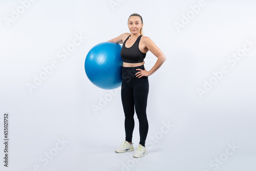 Full body length shot athletic and sporty senior woman with fitness exercising ball on isolated background. Healthy active and body care lifestyle after retirement. Clout