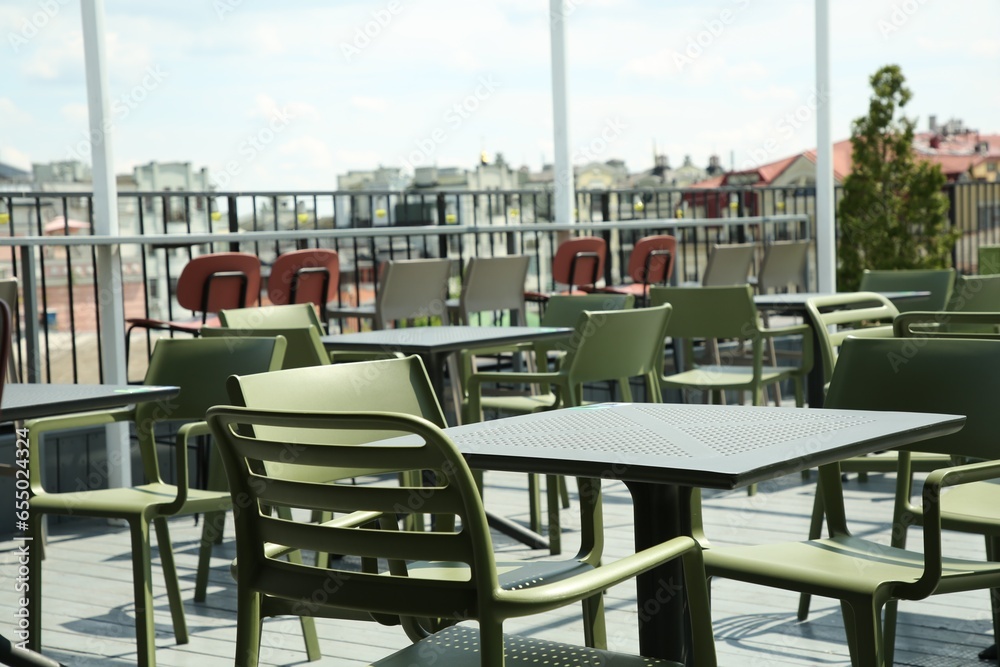 Observation area cafe. Tables and chairs on terrace against beautiful cityscape