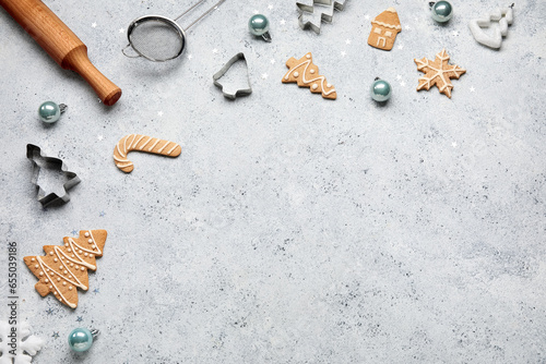 Composition with Christmas cookies, decorations and kitchen utensils on light background