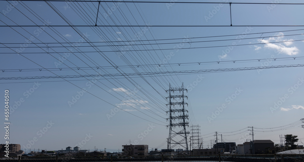Skyward Currents: Transmission Towers Beneath Azure Skies