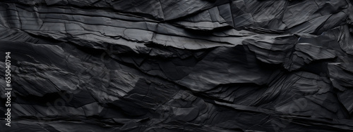 Black and grey background with layers of rocks, in the style of creased crinkled wrinkled.
