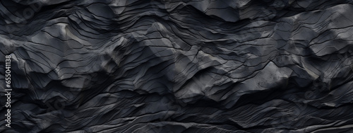 Black and grey background with layers of rocks, in the style of creased crinkled wrinkled. photo
