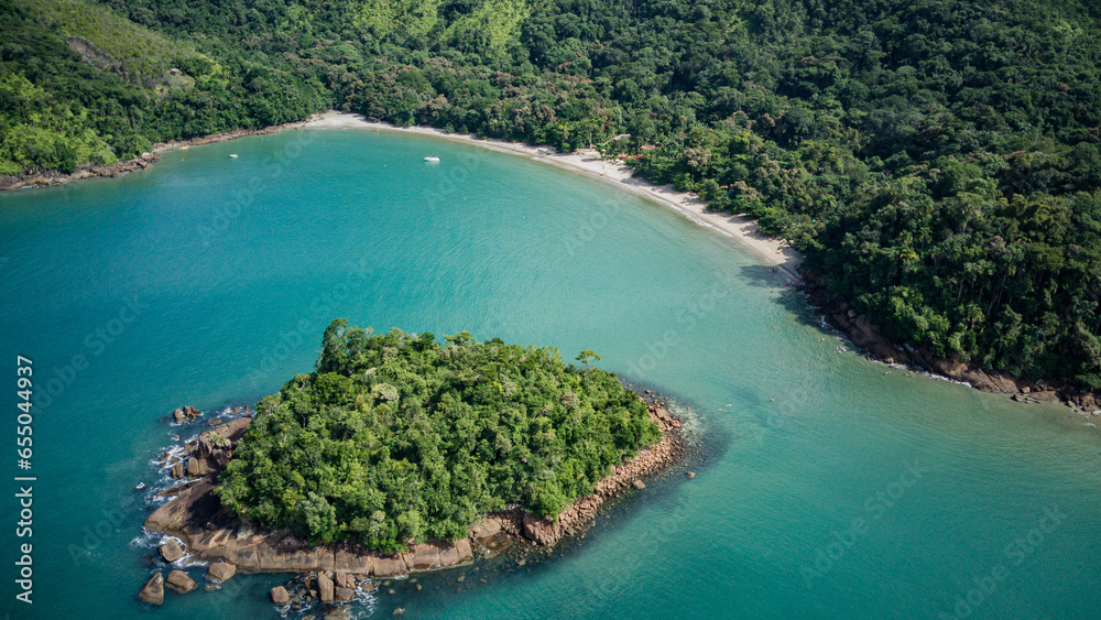 Beach landscape on a sunny day, seen from above, drone photography, calm turquoise waters, with a small island in the foreground, mountains with forest, Praia da Justa, Ubatuba - Sao Paulo - Brasil