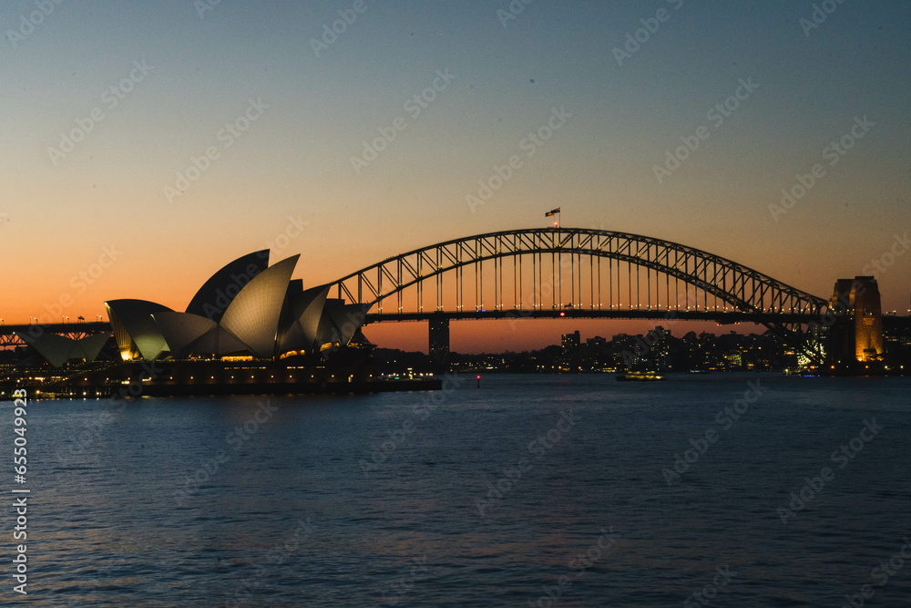 Naklejka premium city harbour bridge and opera house at sunset, Sydney