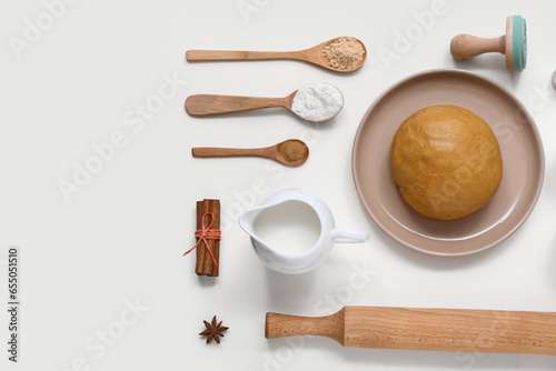 Composition with ingredients and utensils for preparing tasty Christmas cookies on light background