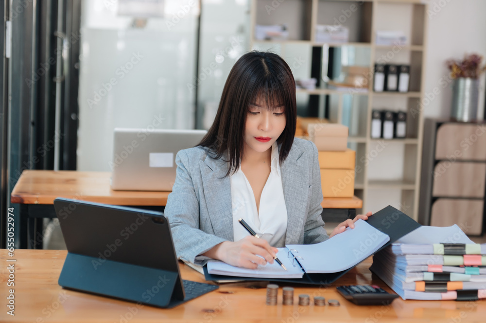 Startup small business SME, Entrepreneur owner woman using smartphone or tablet taking receive and checking online purchase shopping order to preparing pack product box. Startup small business SME, Entrepreneur owner woman using smartphone or tablet taking receive and checking online purchase shopping order to preparing pack product box.