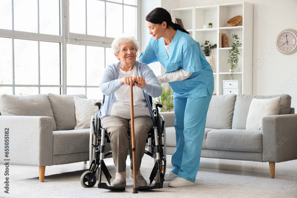 Senior woman in wheelchair with stick and nurse at home Senior woman in wheelchair with stick and nurse at home