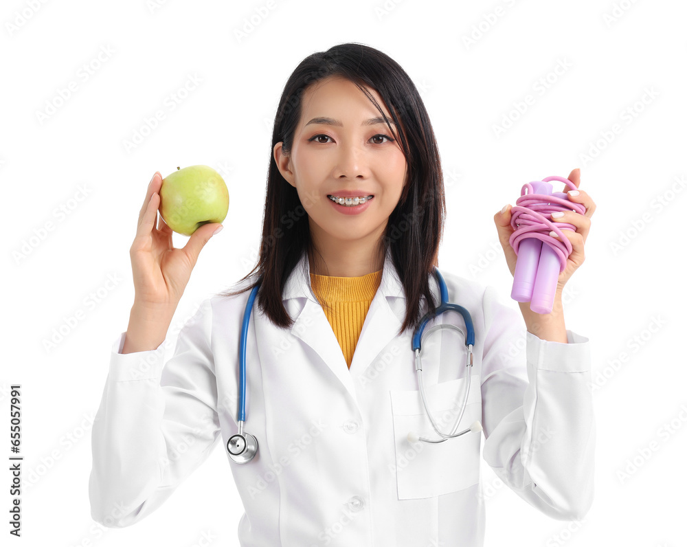 Female Asian nutritionist with apple and skipping rope on white background Female Asian nutritionist with apple and skipping rope on white background
