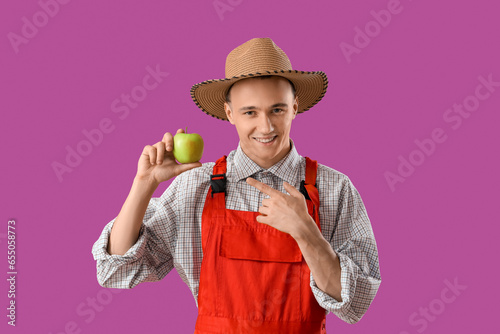 Young farmer pointing at ta...