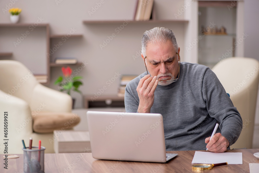 Old male employee working from home during pandemic Old male employee working from home during pandemic