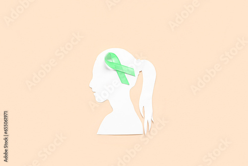 Paper female head with gree...