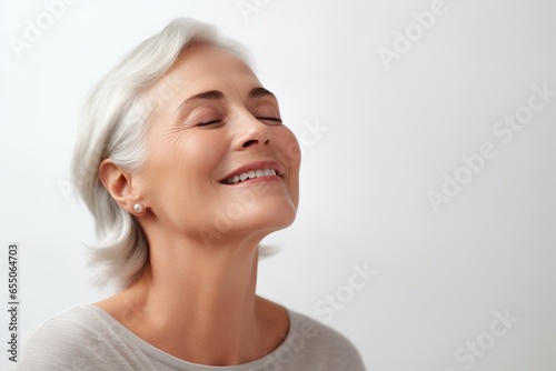 Portrait of a happy senior woman with closed eyes and closed eyes