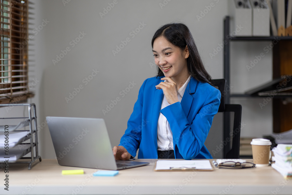 Asian busines or an accountant woman are analyzing data charts, graphs, and a dashboard on a laptop screen in order to prepare a statistical report and discuss financial data in an office. Asian busines or an accountant woman are analyzing data charts, graphs, and a dashboard on a laptop screen in order to prepare a statistical report and discuss financial data in an office.