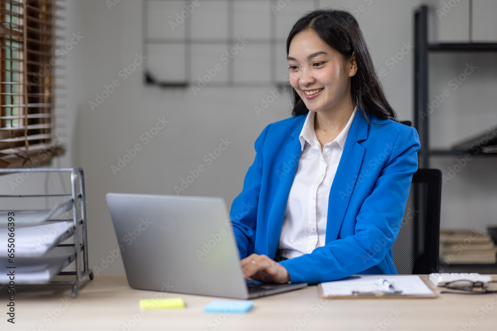 Asian busines or an accountant woman are analyzing data charts, graphs, and a dashboard on a laptop screen in order to prepare a statistical report and discuss financial data in an office. Asian busines or an accountant woman are analyzing data charts, graphs, and a dashboard on a laptop screen in order to prepare a statistical report and discuss financial data in an office.
