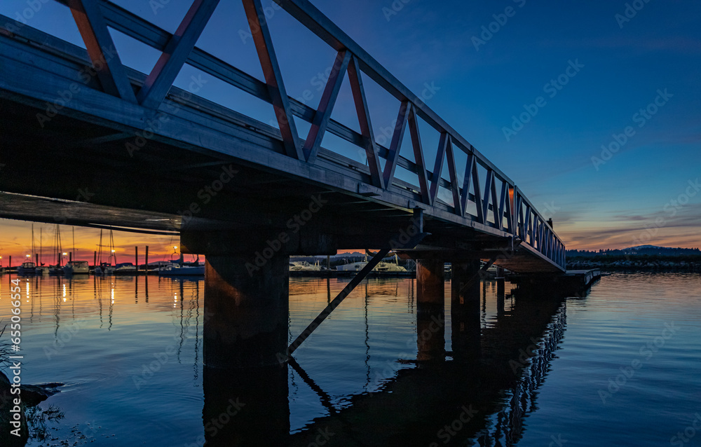 Bridge pier walk in sunset. Pier bridge at night time at West coast