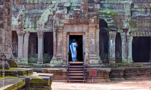 Ta Prohm temple ruins hidden in jungles at Angkor Wat - Wall carving with woman famous Angkor Wat complex  Siem Reap  Cambodia