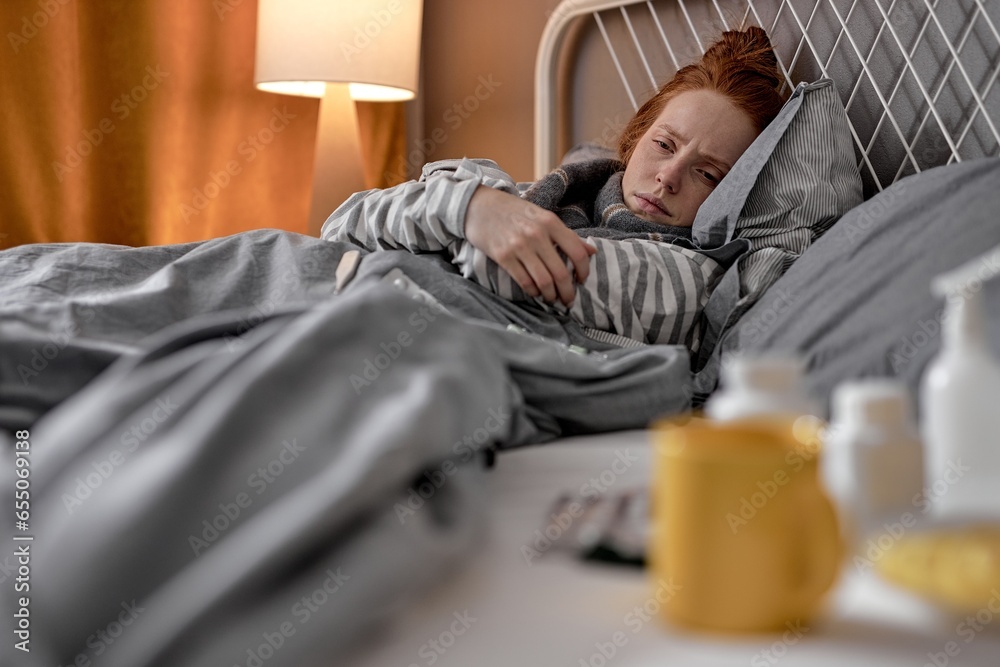 Φωτογραφία unhealthy depressed ginger without force woman lying in bedroom, lonely girl wants to cry, close up portrait