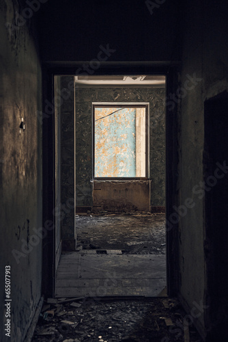 View through the corridor to the window. Abandoned soviet spa resort (sanatorium) Metallurg, in Tskaltubo, Georgia photo