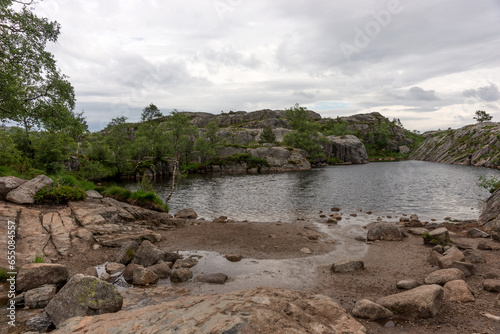 Mountain lake on the side of the tourist route to Preikestolen rock. Norway