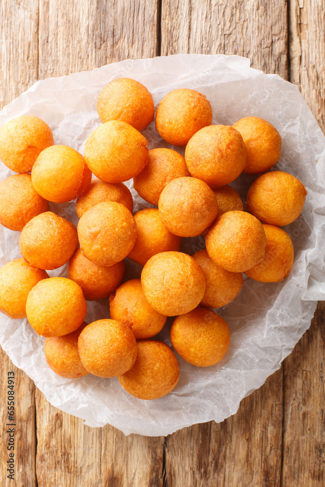 Kanom kai nok krata or fried sweet potato balls, are a common Thai
