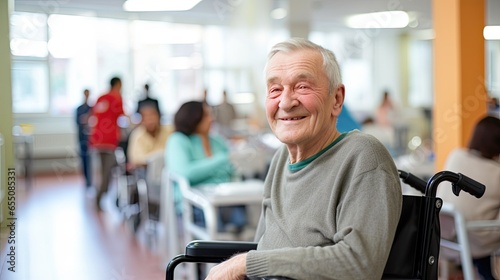 Elderly man smiling happily looking at camera on hospital wheelchair