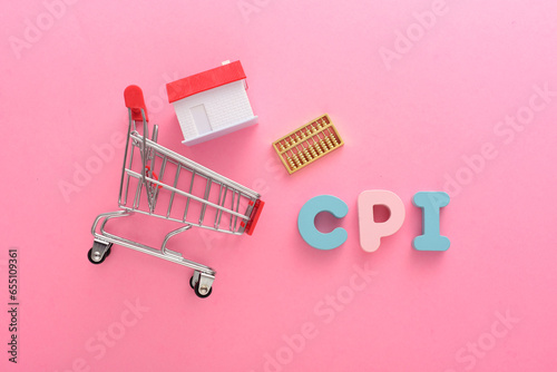 On a pink background, there are shopping carts, small houses, abacus, and the letters CPI