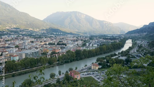 Trento, Italy, landscape of the Adige river and the town at sunset