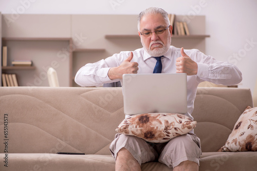 Old male employee working from home during pandemic