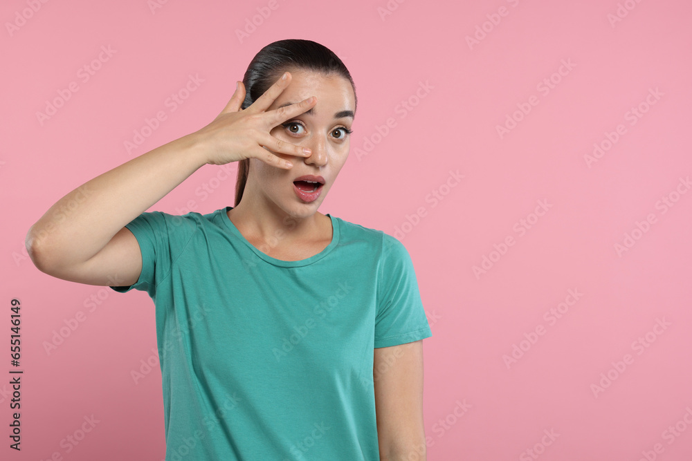 Embarrassed woman covering face on pink background. Space for text Embarrassed woman covering face on pink background. Space for text