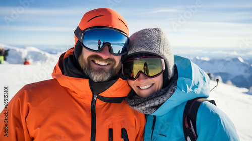 happy couple in ski resort wearing skiing jackets and goggles