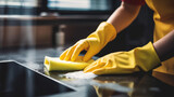 Janitor cleaning white desk in modern kitchen. young cleaning service woman worker cleaning kitchen table at home. housekeeper cleaner wiping cooking counter