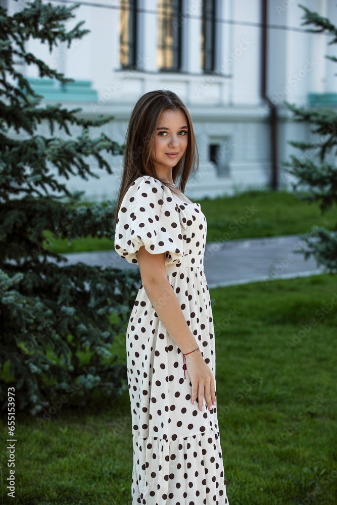 Profile image of a elegant young caucasian girl looking at camera spending free time outdoors. Lifestyle concept