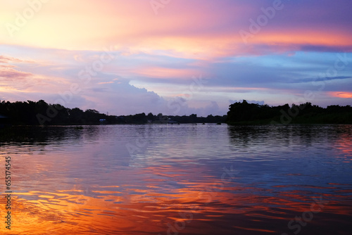 Beautiful Silhouette Sunset and river destination natural reflection of twilight with sunlight in Thailand © cocorattanakorn