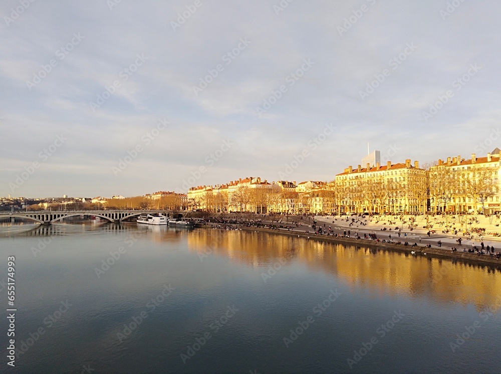 the banks of the Saône, the reflection in the water of the buildings and the bridge which spans the river, in Lyon. France	
