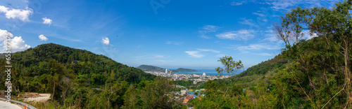 Panorama panoramic Colourful view of Patong Beach Phuket Thailand taken from patong mountains with lush rain forest  © Elias Bitar