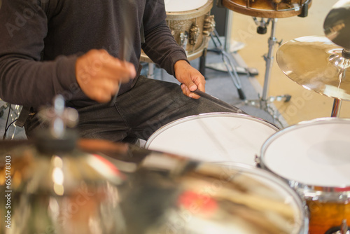 Drummer playing drums in the studio. Close-up of a man playing drums.