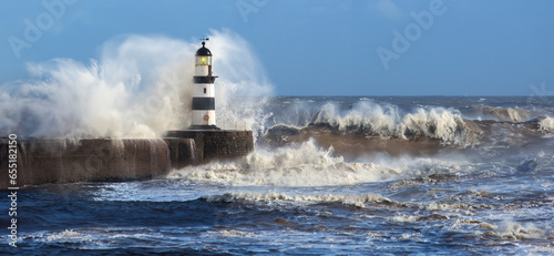 Waves crashing over Seaham Lighthouse in the northeast of England. photo