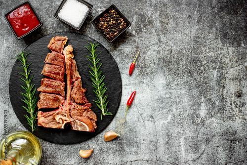 Grilled T-bone steak on stone background with copy space for your text