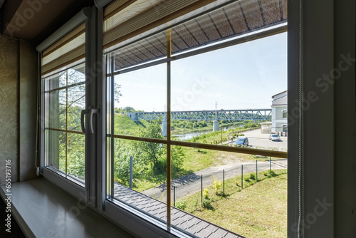 Window in the house with views of nature and the river in the summer