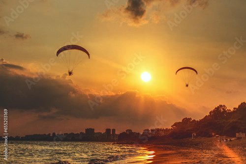 paraglider silhouette at sunset